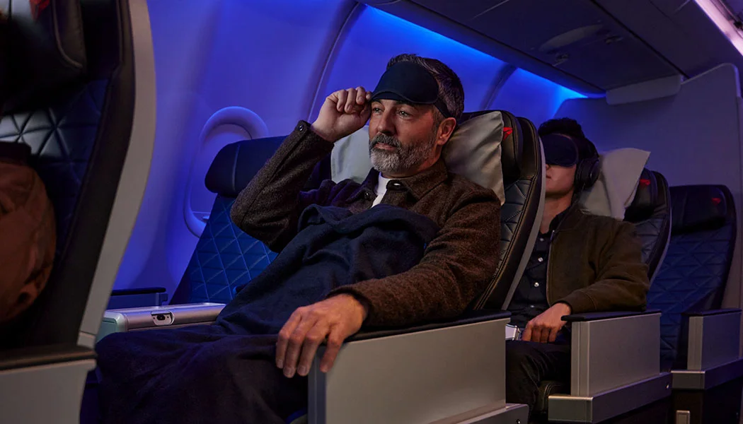 Delta Premium Select passenger resting in a reclined seat